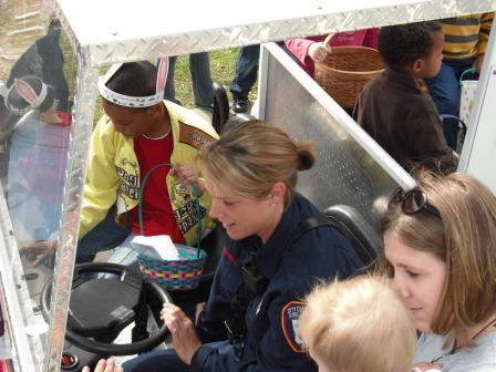 Firefighter Tracey Collins shows the children how to ring the bell.