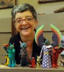 Ann VanSlyke is owner of Mingei World Arts, which is selling the collectible woodcarvings by various artists featuring different figures reading books